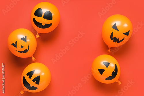 Funny Halloween orange balloons on red background © Pixel-Shot