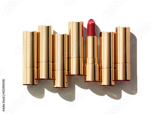 Seven lipsticks composition isolated on white background. Pink red gold cosmetic makeup product sample photo