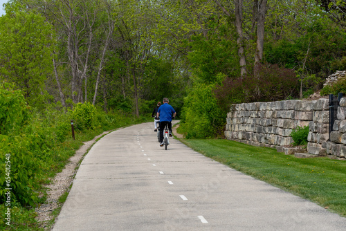 People On Bicycles Enjoying The Fox River Trail Near De Pere, Wisconsin, In Spring
