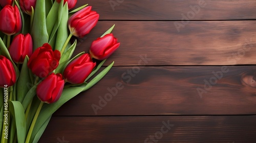 Bouquet of red tulips on a wooden copy space background 