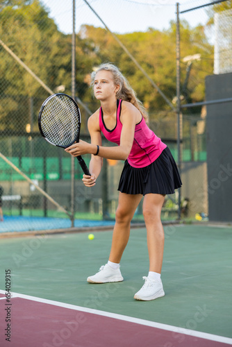 Sports girl is ready to repel an attack while playing tennis © JackF