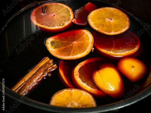 Traditional Swedish Christmas drink, called Glogg, similar to Gluhwein, here being prepared with red wine, oranges and cinnamon. photo