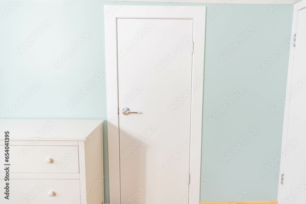 Simple clean home interior design white door with white dresser. Interior backgrounds copy space image. Simple clean home interior design white door with white dresser. Interior backgrounds copy space image.