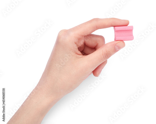 Woman holding tasty pink chewing gum on white background, top view