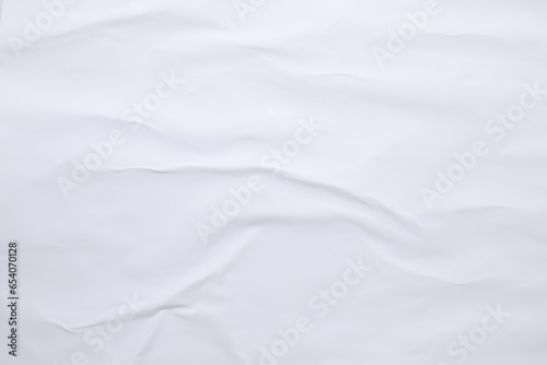 White crumpled sheet of paper as background, top view. Wall poster © New Africa