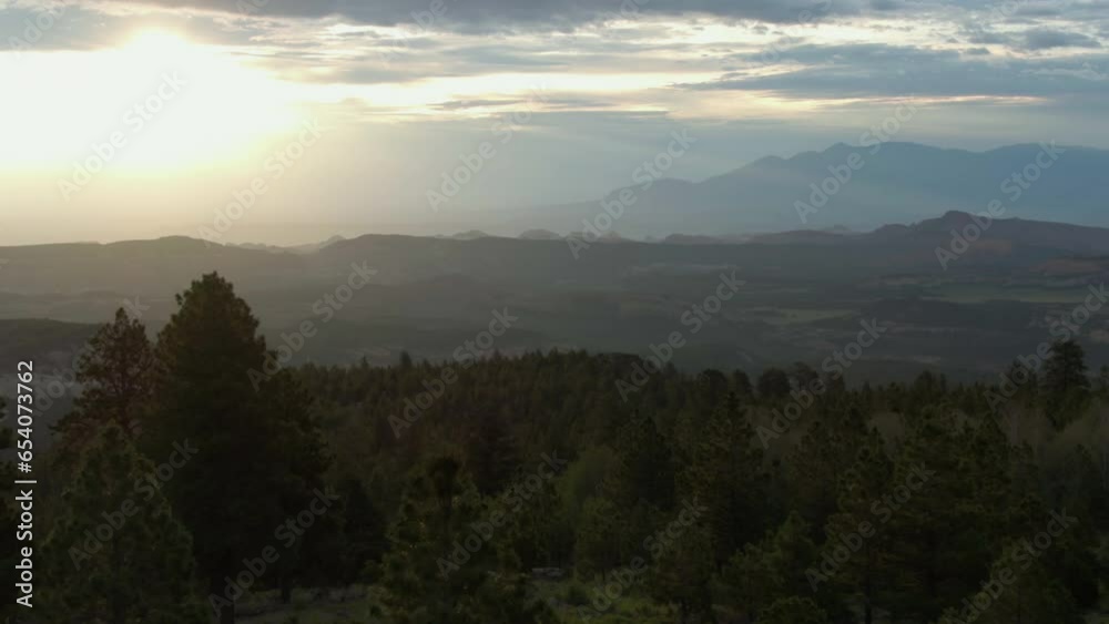 Aerial view rising over trees toward wilderness of Utah, dramatic evening in USA Aerial view rising over trees toward wilderness of Utah, dramatic evening in USA