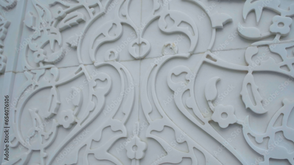 Decorative item made of white plaster on ceiling and wall. Scene. Beautiful ornament and relief interior.