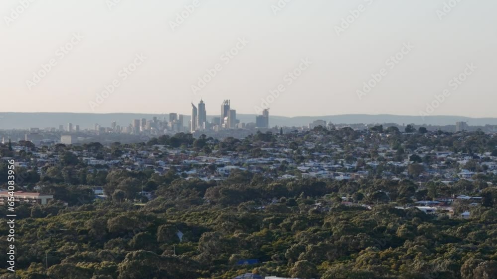 Drone panning around Perth city skyline at sunrise with light rising over the hills of Western Australia Drone panning around Perth city skyline at sunrise with light rising over the hills of Western Australia