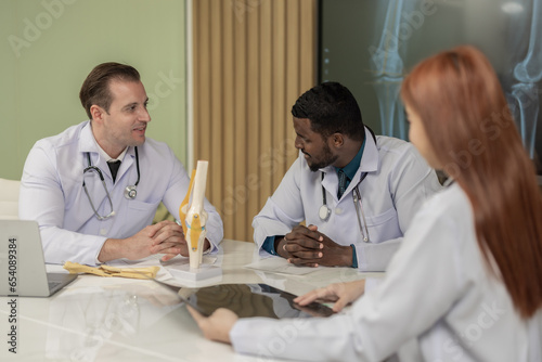 Surgeon and radiologist discuss Patient's knee joint 's MRI, plan for further procedure.