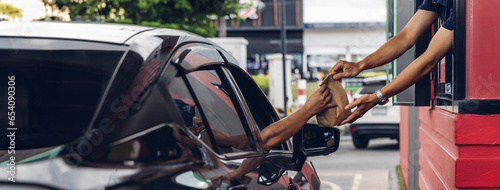 Wallpaper Mural Hand Man in car receiving coffee in drive thru fast food restaurant. Staff serving takeaway order for driver in delivery window. Drive through and takeaway for buy fast food for protect covid19. Torontodigital.ca