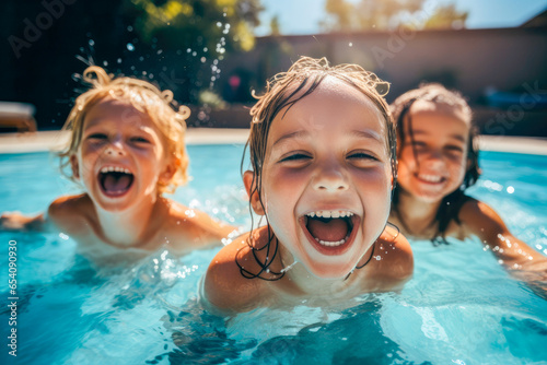 Joyful young children, sharing smiles, water splashes and laughter as they swim together in a public swimming pool, showcasing fun and friendship © MVProductions