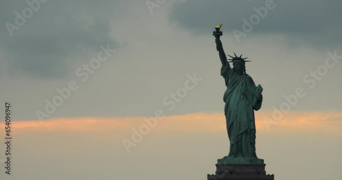 Clouds Moving Slowly Behind Statue of Liberty at Sunset