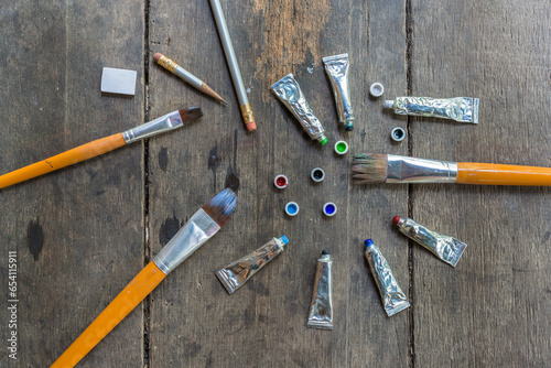 Brushes and watercolors on wooden floors.
