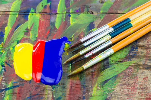 Brushes and watercolors on wooden floors.