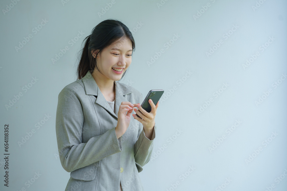 Portrait of a beautiful businesswoman holding a smartphone on a white background. Portrait of a beautiful businesswoman holding a smartphone on a white background.