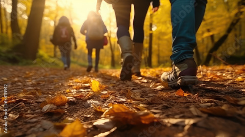 Group of tourists walks along the path of the autumn forest