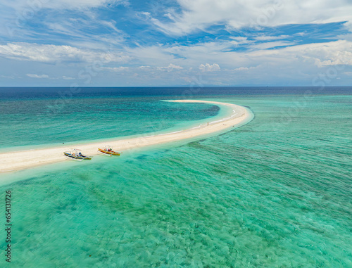 Sandbar with turquoise water and waves at coast. White Island. Camiguin, Philippines. Travel destination.