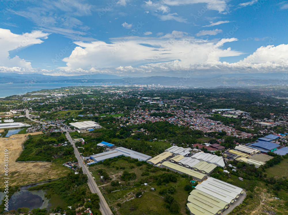 Cagayan de Oro: Busy city in daytime, residential area and commercial buildings. Northern Mindanao, Philippines. Cityscape.