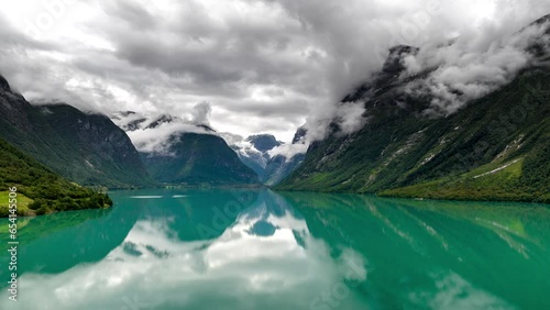 Drone hyperlapse over Loen Lake of mountain fog twirling around Loen mountains photo