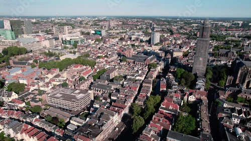 Aerial drone shot flying high over residential houses and roads along the Historic City Center of Utrecht in the Netherlands on a sunny day. photo