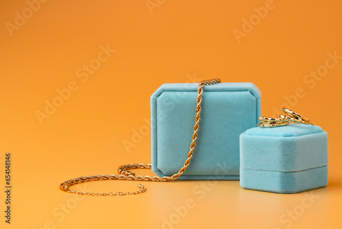 Blue jewelry box on yellow background close up