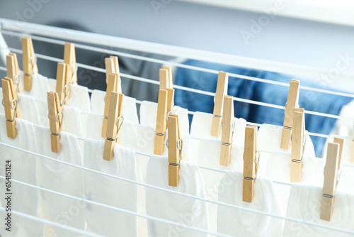 Wooden clothespins with white socks on the dryer