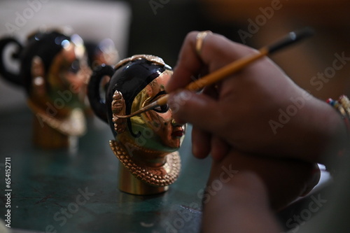 coloring of Goddess face. Hindu Goddess making statue. Face coloring proccess. Brush and hand. Mahalakshmi, Durga face. Navratri, Dusshera 