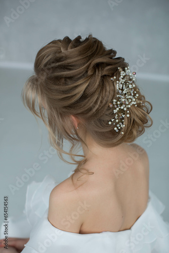 Wedding beautiful hairstyle on blonde hair with pearls and rhinestones decoration