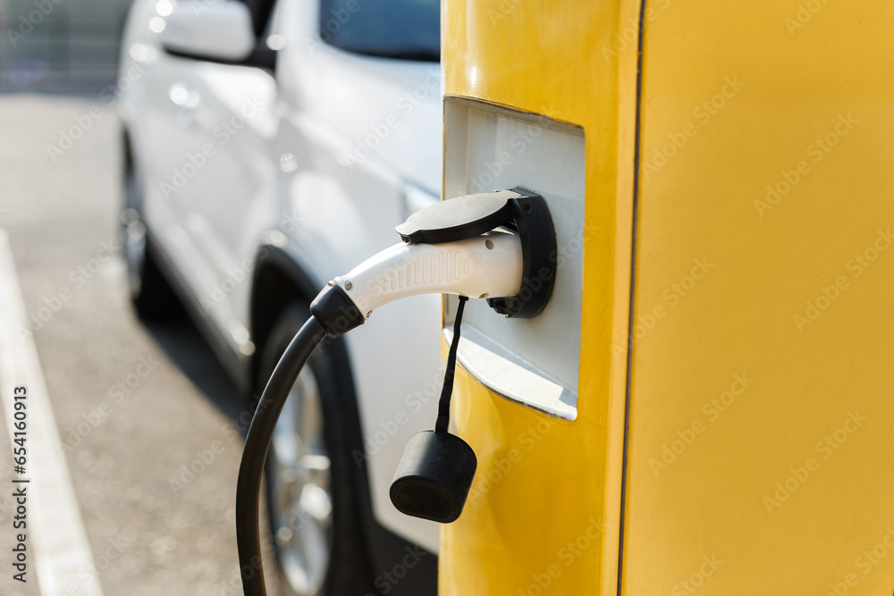 Power supply connect to electric vehicle for charge to the battery. EV fuel Plug in hybrid car Power supply connect to electric vehicle for charge to the battery. EV fuel Plug in hybrid car