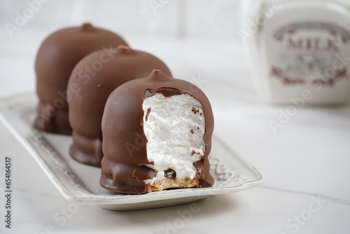 Chocolate-coated marshmallow. Krembo on the table with a cookies. Classic Israeli childhood snack Krembo.