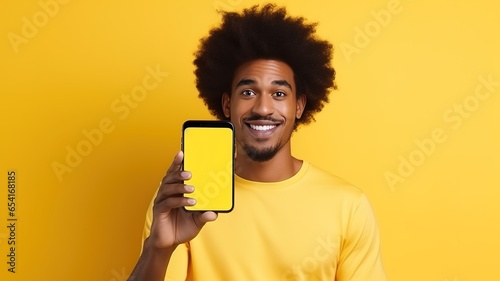 happy attractive african american man showing blank mobile phone screen recommending app smiling at camera on yellow background. Mobile application advertising. AI.