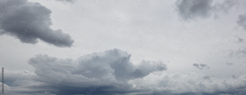 Panoramic photo of Dramatic dark clouds before rainy. Beautiful cloudscape over horizon, sky