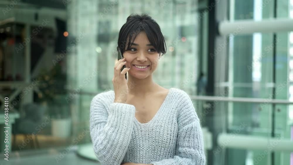 Portrait shot of happy smiling asian young woman chatting on the phone, open space common area of business center. Close up of asian girl having a call Portrait shot of happy smiling asian young woman chatting on the phone, open space common area of business center. Close up of asian girl having a call