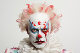 Portrait Captures The Unsettling Visage Of Deranged Clown, Complete With Eccentric Makeup, Prominent Red Nose, And Flamboyant Costume, Set Against White Backdrop
