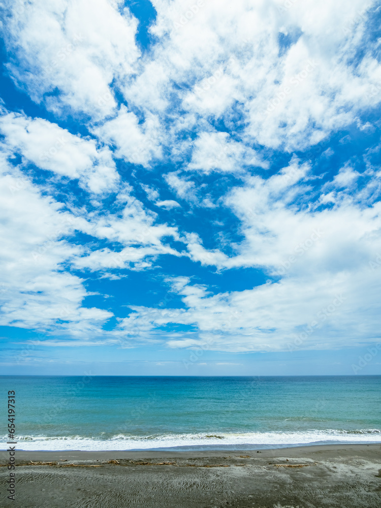 The Seashore and the Blue Sky with White Clouds