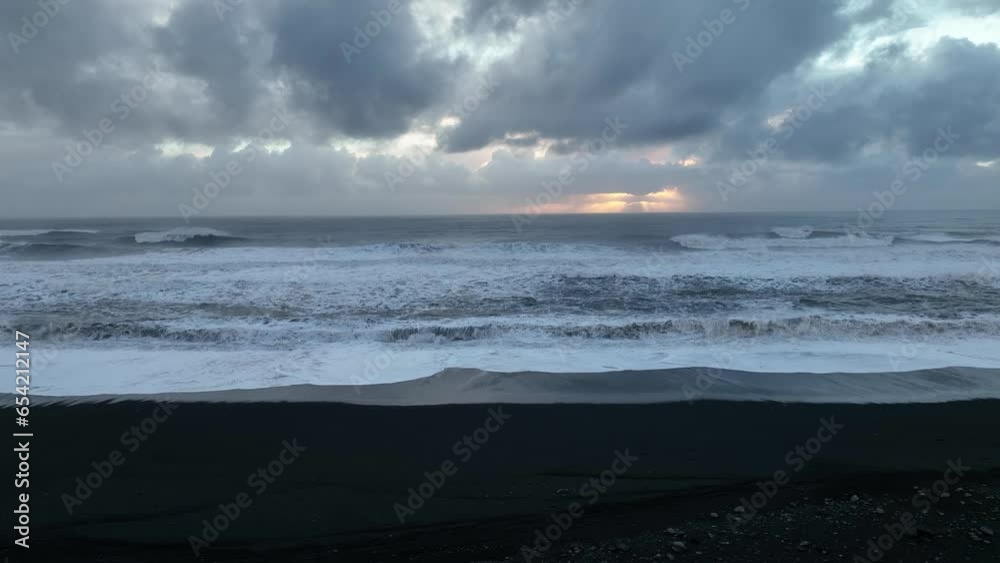 Aerial landscape view of ocean waves crashing on Iceland Sólheimasandur black sand beach, on a cloudy sunset Aerial landscape view of ocean waves crashing on Iceland Sólheimasandur black sand beach, on a cloudy sunset