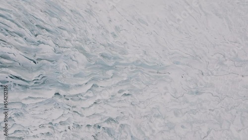 Aerial landscape view over ice textures and formations in Virkisjokull glacier covered in snow, Iceland photo