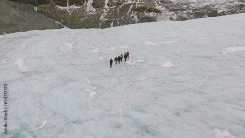 Aerial view of people hiking on the ice surface of Virkisjokull glacier, Iceland photo