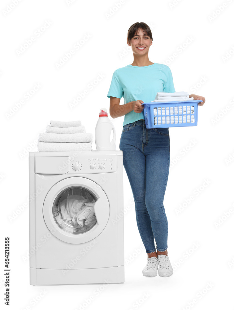 Beautiful woman with laundry basket near washing machine on white background Beautiful woman with laundry basket near washing machine on white background
