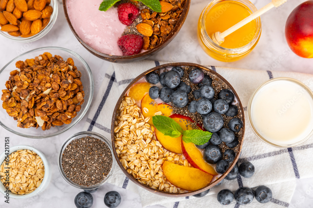 Granola bowl. Yogurt with oatmeal, fresh berries, spirulina and chia seeds. Healthly food. Tasty breakfast. Yogurt with strawberries, raspberries, blueberries, peaches, mint and mendal. Copy space. Granola bowl. Yogurt with oatmeal, fresh berries, spirulina and chia seeds. Healthly food. Tasty breakfast. Yogurt with strawberries, raspberries, blueberries, peaches, mint and mendal. Copy space.