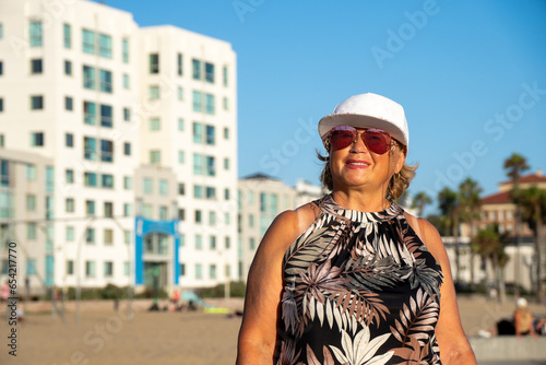 Senior Woman with sunglasses Enjoying walking on Los Angeles Beach