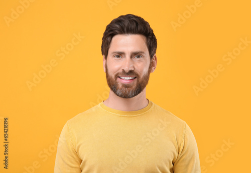 Portrait of handsome man on orange background