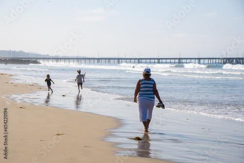 Senior Woman with sunglasses Enjoying walking on Los Angeles Beach