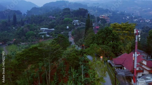 Forward aerial view of a narrow road going through hills, near Dago Pakar - Jl. Bukit Timur - Bandung, Indonesia photo