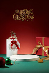 Christmas concept with a red gift box featured with a reindeer and two small baubles. Empty area on the podium for product or goods presentation