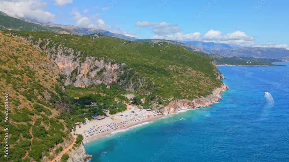 Aerial forward moving shot of turquise sea water of the Ionian Sea alongside Gjipe beach, Albania on a sunny day. Aerial forward moving shot of turquise sea water of the Ionian Sea alongside Gjipe beach, Albania on a sunny day.