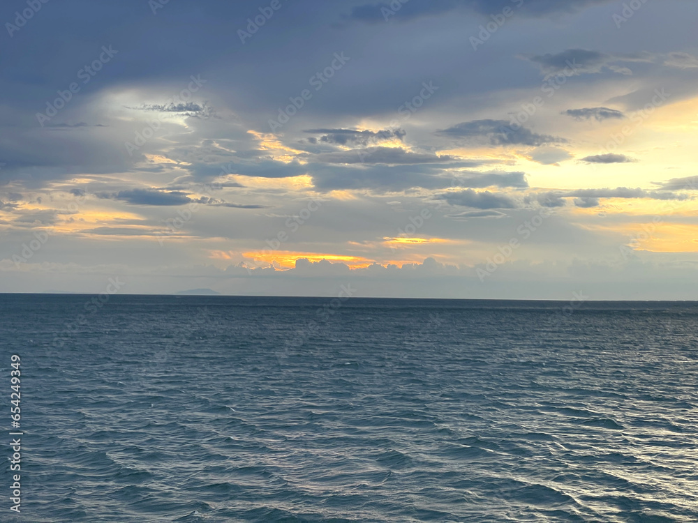 Landscape Long exposure of majestic clouds in the sky sunset or sunrise over sea with reflection in the tropical sea.Beautiful cloudscape scenery.Amazing light of nature Landscape nature background