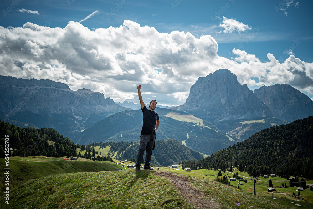 a happy hiker guy reached the top of the mountain, Dolomites 