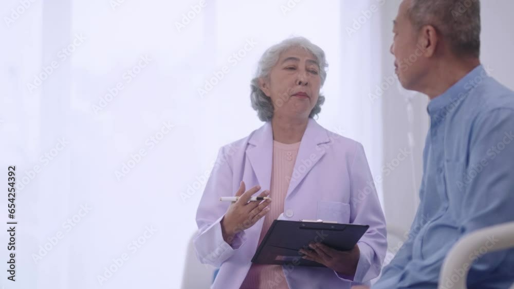 Senior Asian Women Doctor talking during medical checkup at clinic consultation with senior male patient in examination room, healthcare or support in hospital. Senior Asian Women Doctor talking during medical checkup at clinic consultation with senior male patient in examination room, healthcare or support in hospital.