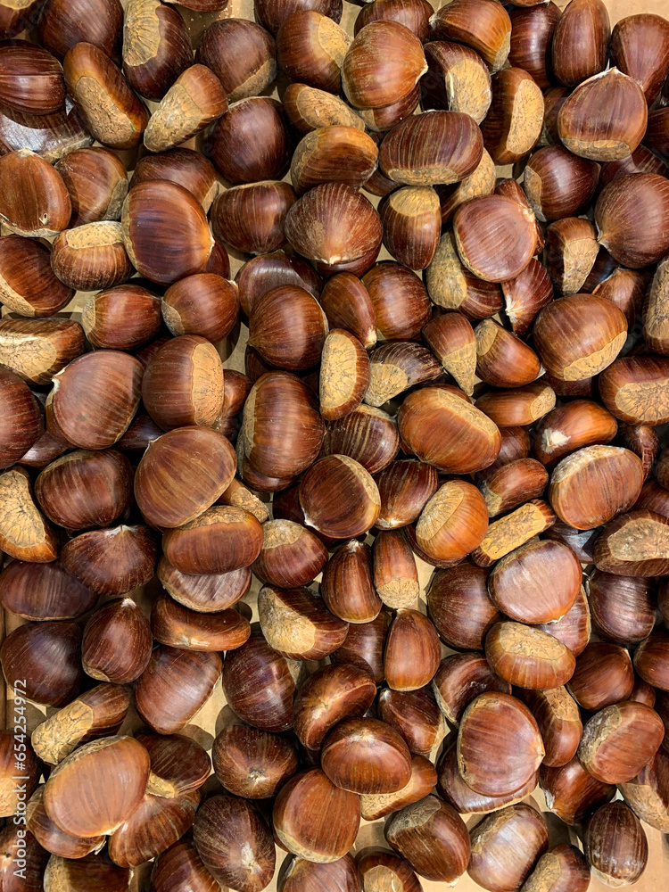 Grocery background with chestnuts scattered on the store counter Grocery background with chestnuts scattered on the store counter